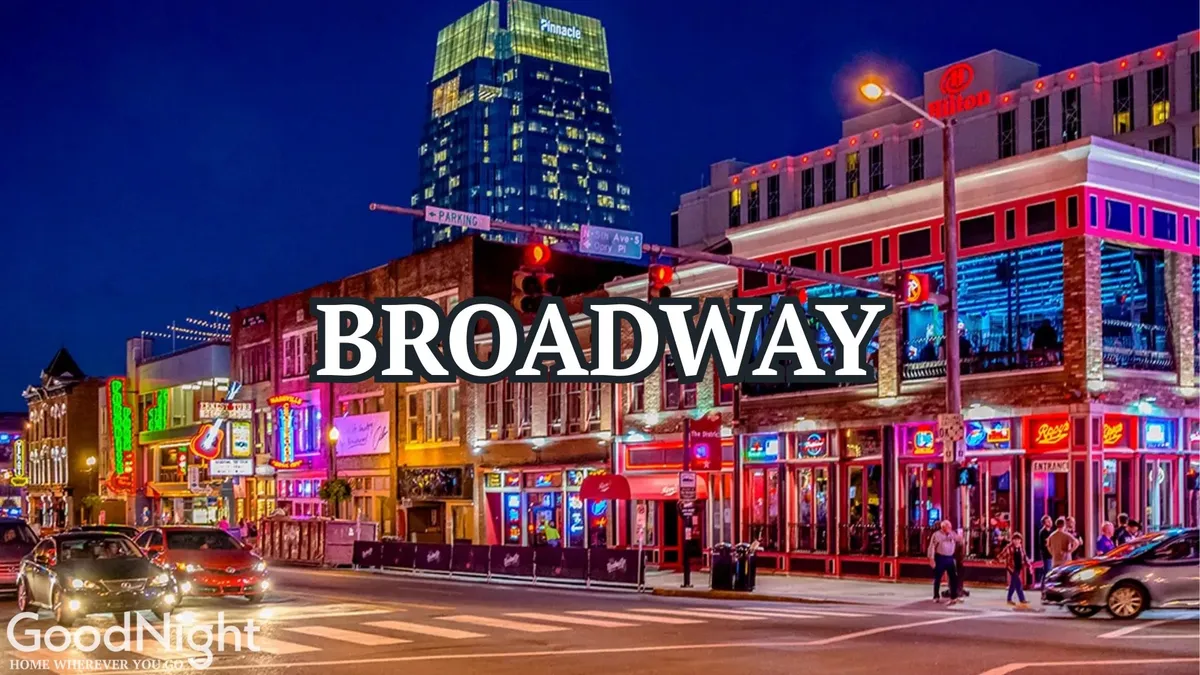 A vibrant nighttime street scene in downtown Nashville, featuring neon signs, bustling crowds, nightlife venues, and high-rise buildings. The image captures the essence of Nashville’s buzzing evenings, with people moving between restaurants and live music bars, all illuminated by colorful lights.